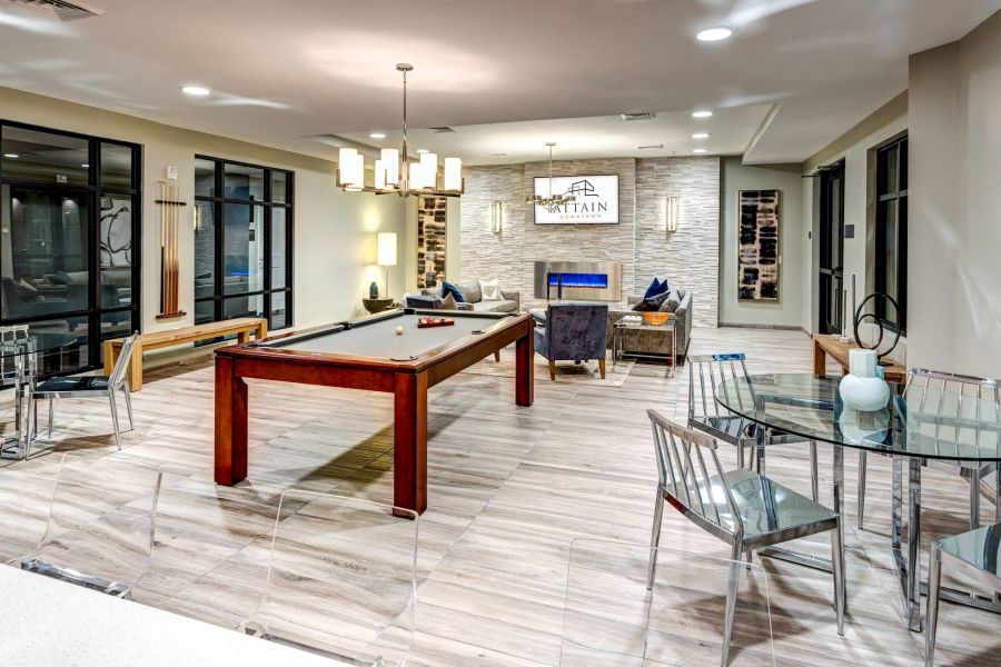 Attain Downtown apartment homes with Modern game room with a pool table, lounge chairs, glass tables, and contemporary decor.